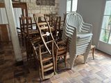 many chairs and a table in a room with a brick wall