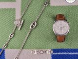 a watch and a chain on a blanket