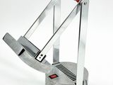 a metal object with a red handle on a white surface