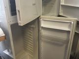 a white refrigerator with its door open in a kitchen