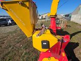 a close up of a red and yellow machine in a field