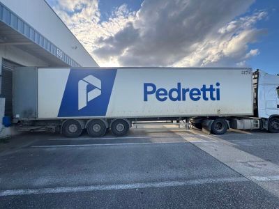 a semi truck that is parked in front of a building