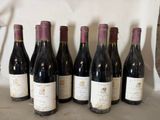 six bottles of wine are lined up in a row on a table