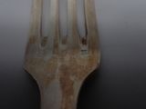 a wooden fork with a metal handle on a table