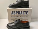 men ' s black leather shoes with laces on top of a box