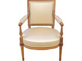 an image of a wooden chair with a beige upholstered seat
