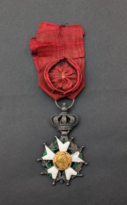a close up of a medal with a red ribbon around it