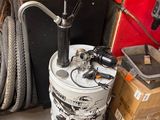 a bike that is sitting on the floor next to a bucket