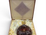 a bottle of liquor in a box on a white surface