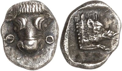 a close up of a coin with a goat on it
