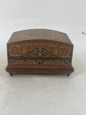 an old wooden box sitting on top of a snow covered ground
