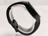 a close up of a watch on a clear stand