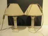 two lamps that are sitting on a white table