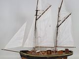 a model of a sailboat on display on a table