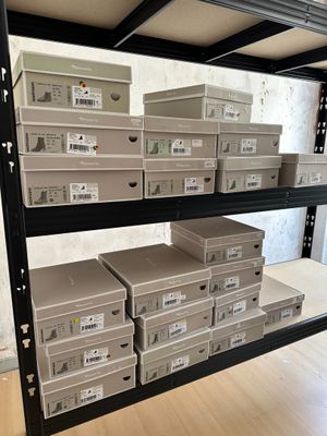 many boxes that are on the shelves in the room