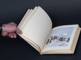 a person holding an open book with a picture on it