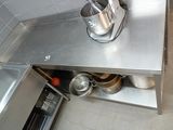 a stainless steel counter with pots and pans on it
