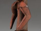 an old wooden statue of a man with a hat on his head