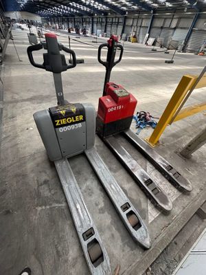 a forklift that is sitting on the ground in a warehouse