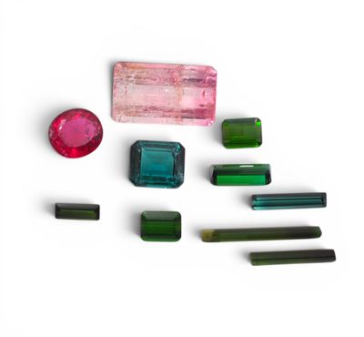 several different colored gems are arranged on a white surface