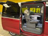 a red van with its doors open in a garage