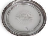 silver plate with a starburst design on the rim