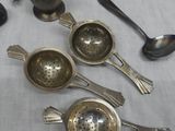 a lot of silver spoons and spoons on a table