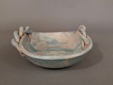 a small bowl with a handle on it