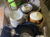 pile of dirty dishes and pans sitting on top of a wooden box