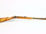 an old rifle with a wooden barrel on a white background
