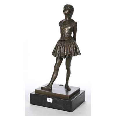 a bronze statue of a young girl in a tutu skirt