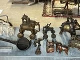 a lot of antique items on display in a glass case