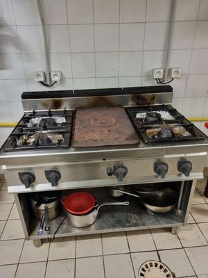 a kitchen with a stove and a pot on the counter