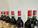 several bottles of wine are lined up on a table