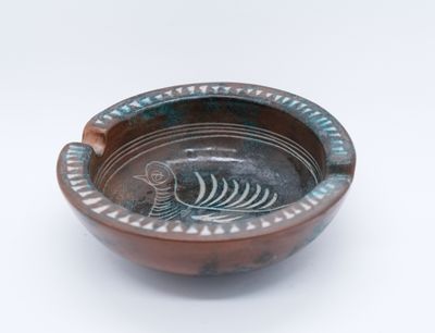 a small bowl with a fish design on it