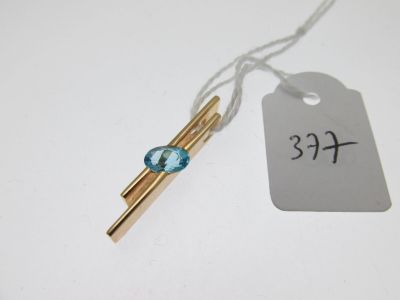 a small blue glass bead hanging from a string