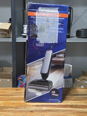 the box of the mop is sitting on the table next to the box