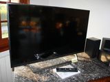 a flat screen tv sitting on top of a table