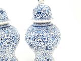 two blue and white vases sitting next to each other