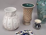 three vases and a coaster on the table