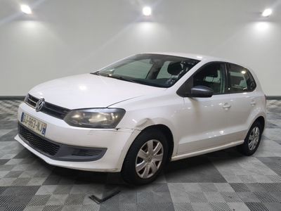 the white volkswagen polo is parked on a checkered tile floor