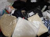 a pile of clothes and other items that are in a suitcase