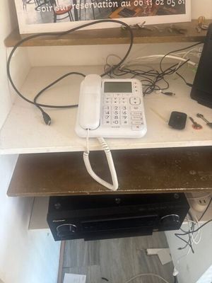 a picture of a desk with a phone and a laptop