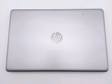 hp laptop computer sitting on a white surface with a logo on the screen