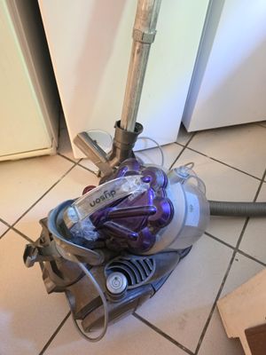 a vacuum that is sitting on the floor in the kitchen