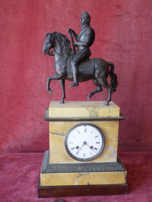statue of a man riding a horse on top of a clock