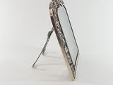 silver plated picture frame with mirror on stand on white background
