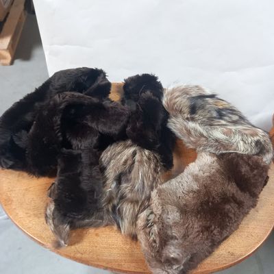 a pile of fur on top of a wooden chair