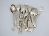 a lot of silver spoons and forks on the table