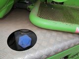 a close up of a green machine with a blue cap
